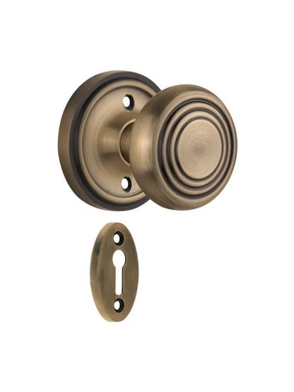 Classic Rosette Mortise Lock Set with Deco Style Knobs in Antique Brass.